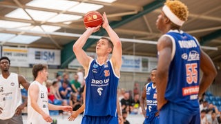 Basketballer Hendrik Warner steigt im Trikot von Syntainics MBC zum Wurf hoch.