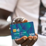 Mann mit dunkler Hautfarbe hält eine Social-Card für Flüchtlinge (Archivbild)