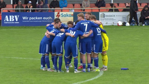 Spieler des Bremer SV stehen in einem Kreis.