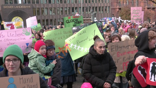 Elternvereine fordern mit buten Plakaten und Schildern auf einer Demo eine Erhöhung ihrer Zuschüsse.