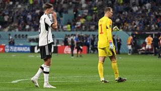 Werder-Stürmer Niclas Füllkrug steht nach der WM-Niederlage gegen Japan enttäuscht auf dem Rasen.