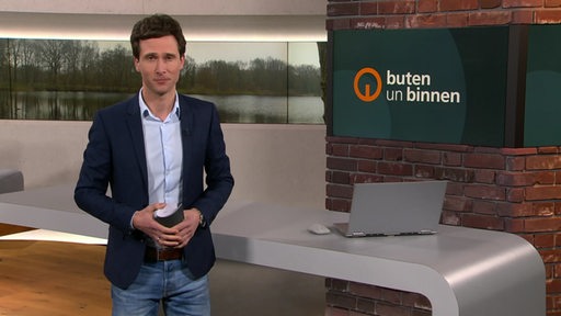 Moderator János Kereszti im Studio von buten un binnen.