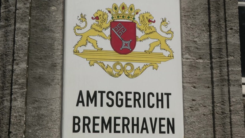 Ein Schild mit dem großen Bremer Stadtwappen und dem Schriftzug Amtsgericht Bremerhaven an einer Wand