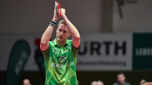 Werders Tischtennis-Profi Mattias Falck applaudiert nach dem Match den Fans mit seinem Schläger in der Hand.